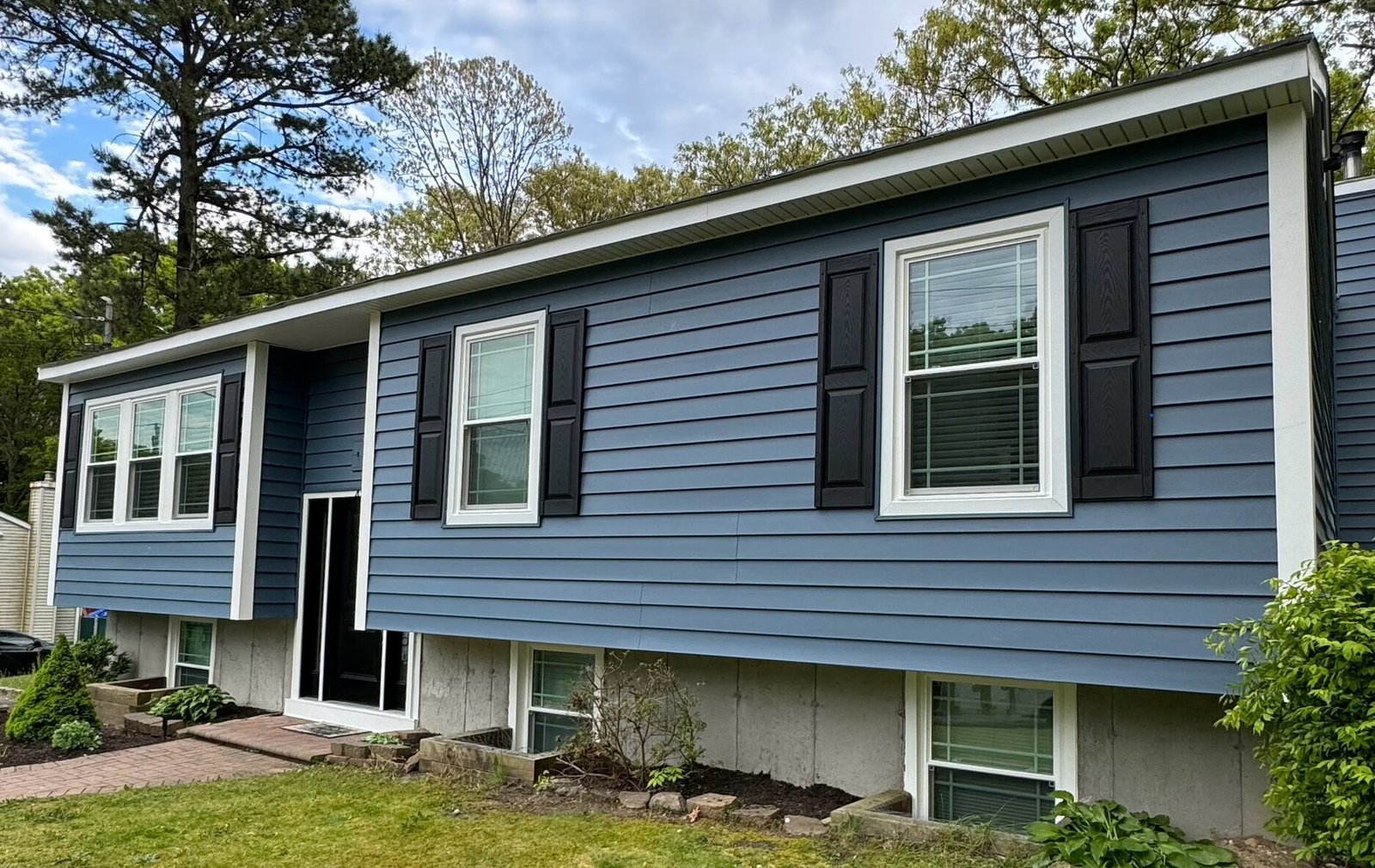 Contractor installing siding panels on house